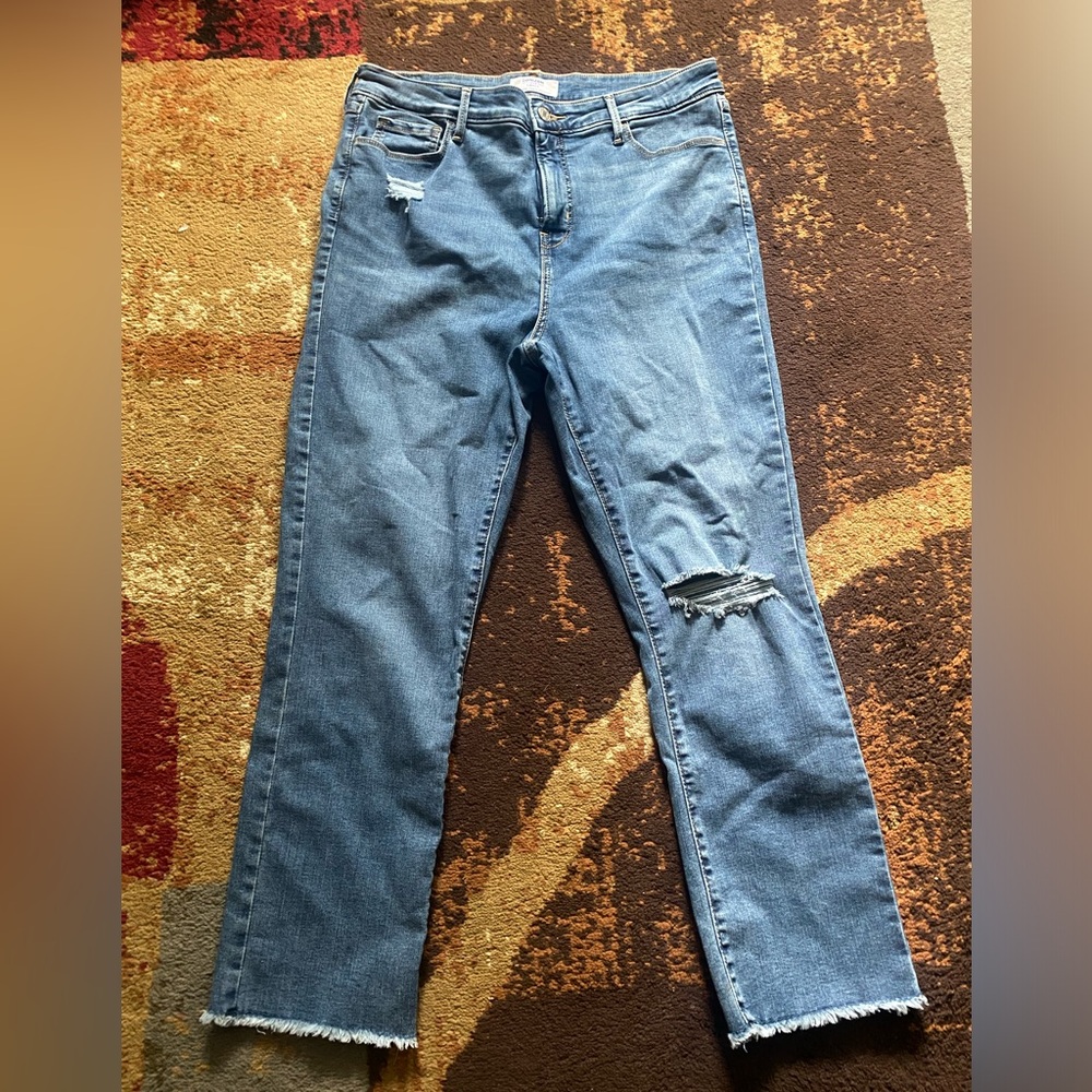 Light wash blue jeans with distressed knees